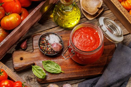 Photo for Rich homemade tomato sauce and ingredients - Royalty Free Image