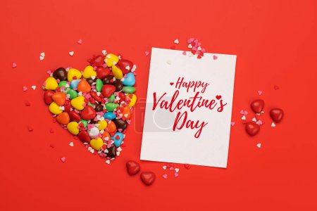 Foto de Dulces dulces y tarjeta de felicitación para sus saludos. San Valentín corazones de caramelo día. Puesta plana - Imagen libre de derechos