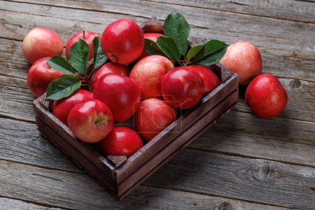 Photo for Wooden box with fresh red apples on wood table - Royalty Free Image
