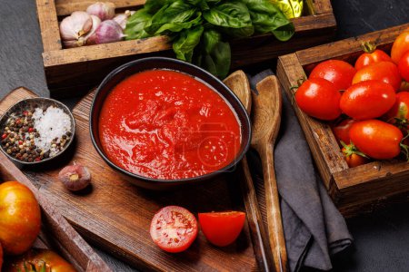 Photo for Rich homemade tomato sauce and ingredients - Royalty Free Image