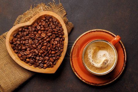 Photo for Coffee love: A cup and heart-shaped bowl with roasted beans. Flat lay - Royalty Free Image
