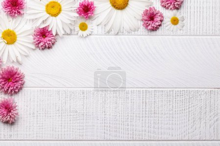 Photo for Assorted garden blossom flower heads on wooden background with space for text. Flat lay - Royalty Free Image