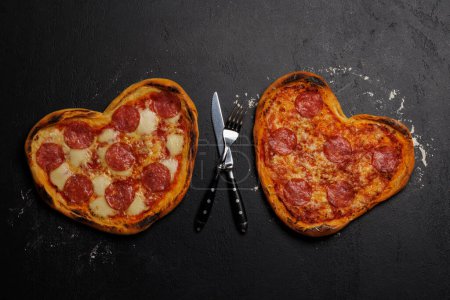 Photo for Heart-shaped pizzas: Delicious love-themed dish. Flat lay - Royalty Free Image