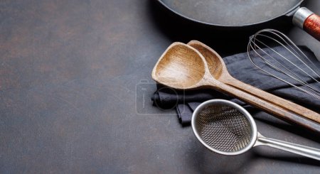 Photo for Culinary essentials: Diverse cooking utensils on stone table. With copy space - Royalty Free Image