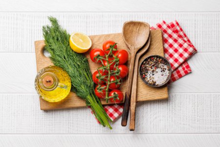 Photo for Cooking scene: Cherry tomatoes, herbs and spices on table. Flat lay - Royalty Free Image