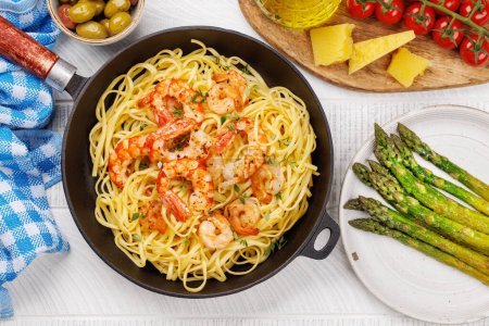 Photo for A delightful Italian pasta adorned with shrimps with thyme, creating a perfect seafood indulgence. Flat lay - Royalty Free Image