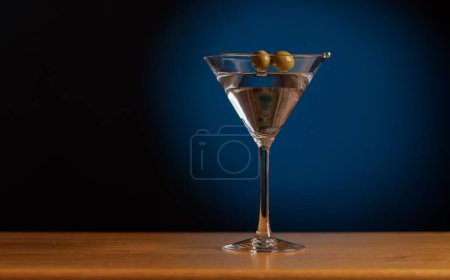 Photo for Cocktail allure: Classic martini cocktail on a bar table with copy space - Royalty Free Image