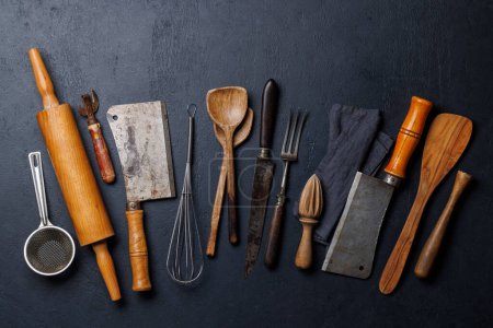 Photo for Culinary essentials: Diverse cooking utensils on stone table. Flat lay - Royalty Free Image
