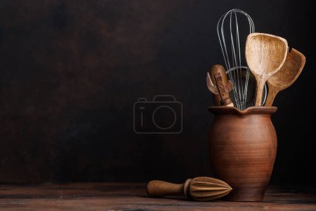 Photo for Culinary essentials: Diverse cooking utensils on kitchen table. With copy space - Royalty Free Image