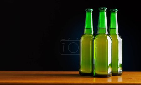 Foto de Cerveza en el bar: Botellas en una mesa de madera. Con espacio de copia - Imagen libre de derechos