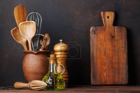 Photo for Culinary essentials: Diverse cooking utensils and spices on kitchen table - Royalty Free Image