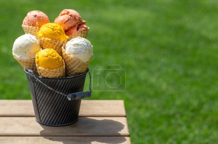 Photo for Assorted ice cream flavours in delightful waffle cones, a treat for every taste bud. Outdoor with copy space - Royalty Free Image