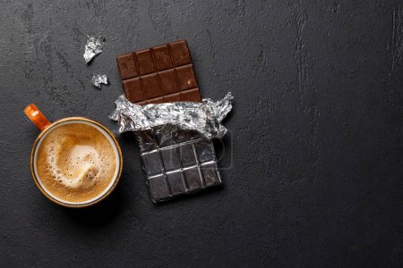 Coffee break bliss: Chocolate bar paired with a cup of coffee. Flat lay with copy space