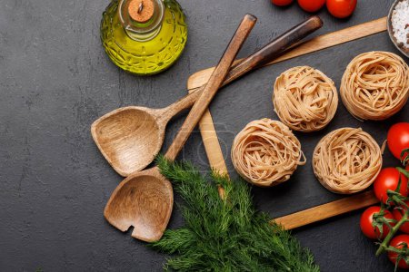 Photo for Cooking scene: Cherry tomatoes, pasta, spices on table. Flat lay - Royalty Free Image
