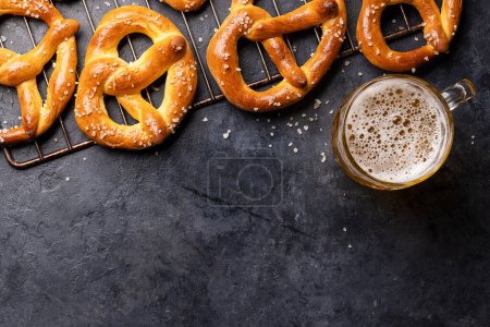Photo for Freshly baked homemade pretzels and draft beer. Flat lay with copy space - Royalty Free Image