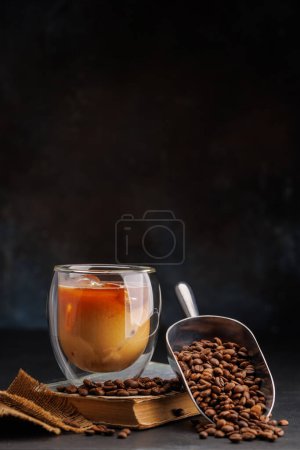 Iced cold brew coffee and freshly roasted coffee beans. With copy space