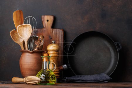 Photo for Culinary essentials: Diverse cooking utensils and spices on kitchen table - Royalty Free Image