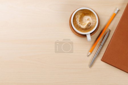 Workplace essentials: Coffee, notepad and supplies. Flat lay with copy space