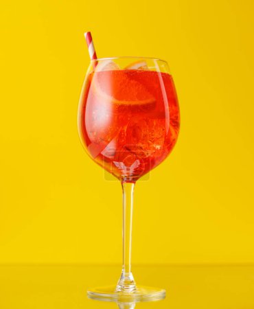 Photo for Aperol spritz cocktail with orange slice and ice on yellow - Royalty Free Image