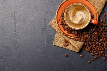 Roasted coffee beans and espresso coffee cup. Flat lay with copy space