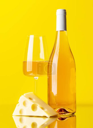 Photo for Aromatic rose wine poured into a glass, accompanied by a tempting piece of cheese - Royalty Free Image
