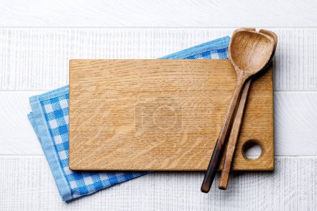 Photo for Culinary essentials: Cooking wooden board on wood table table. Flat lay with copy space - Royalty Free Image