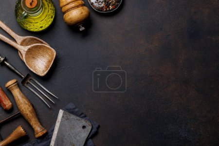 Photo for Culinary essentials: Diverse cooking utensils and spices on stone table. Flat lay with copy space - Royalty Free Image