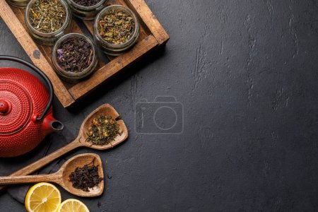 Photo for Tea time assortment: Various dry tea leaves and teapot. Flat lay with copy space - Royalty Free Image