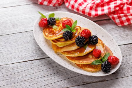 Photo for Tasty homemade pancakes with berries and honey syrup. With copy space - Royalty Free Image