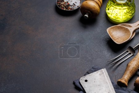 Photo for Culinary essentials: Diverse cooking utensils and spices on stone table. With copy space - Royalty Free Image