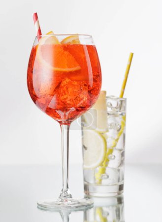 Aperol spritz and gin tonic cocktails on grey with copy space