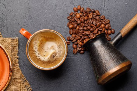 Roasted coffee beans and espresso coffee cup. Flat lay