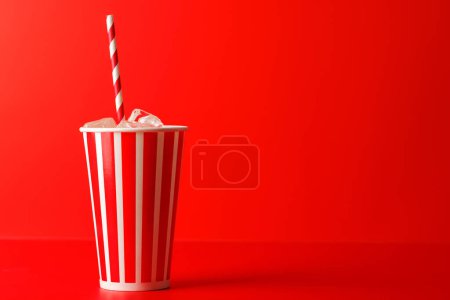 Photo for Paper cup with cola and ice over red background, with copy space - Royalty Free Image
