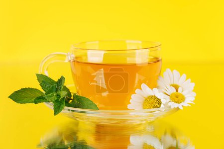 Soothing herbal tea blend with mint and chamomile. On yellow background