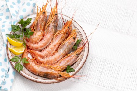 Téléchargez les photos : Fruits de mer frais tels que les langoustines. Pose plate sur table en bois avec espace de copie - en image libre de droit