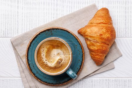 Photo for Cappuccino coffee and fresh croissant on wooden table. Flat lay - Royalty Free Image