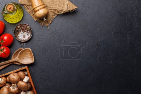 Spices, olive oil, ingredients and utensils on cooking table. Flat lay with copy space