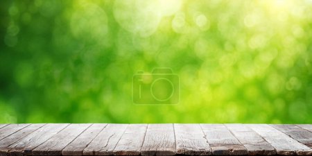 Photo for Empty wooden table over blurred sunny bokeh natural background with space for your product - Royalty Free Image