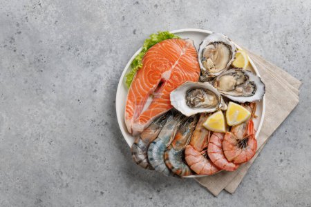 Photo for Seafood Platter Delight: Shrimps, Salmon, Oysters Galore. Flat lay with copy space - Royalty Free Image