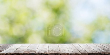 Photo for Empty wooden table over blurred sunny bokeh natural background with space for your product - Royalty Free Image