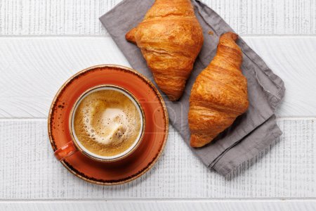 Photo for Cappuccino coffee and fresh croissants on wooden table. Flat lay with copy space - Royalty Free Image