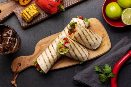 Photo for Mexican food featuring burritos with meat and grilled vegetables - Royalty Free Image