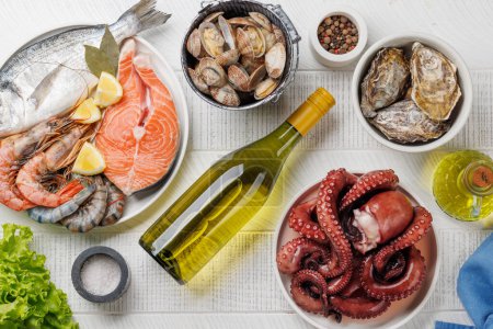 Photo for Seafood Platter Delight: Shrimps, Salmon, Oysters Galore and wine bottles - Royalty Free Image