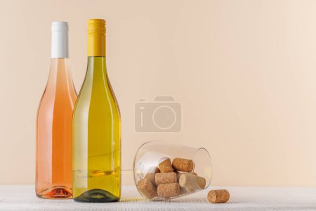 Photo for Rose and White Wine Bottles on Table with copy space - Royalty Free Image