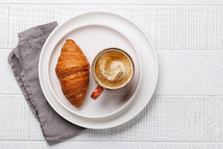 Photo for Cappuccino coffee and fresh croissant on wooden table. Flat lay with copy space - Royalty Free Image