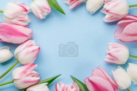 Photo for Pastel colorful tulips grace the table, providing a serene and vibrant backdrop, perfect for spring celebrations or simple joys - Royalty Free Image