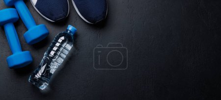 Photo for Fitness concept background with sneakers, dumbbells and towel. Top view with space for your text - Royalty Free Image