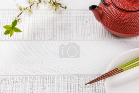 Photo for Table adorned with cherry blossom branch and chopsticks, epitomizing Japanese food culture, providing ample copy space - Royalty Free Image