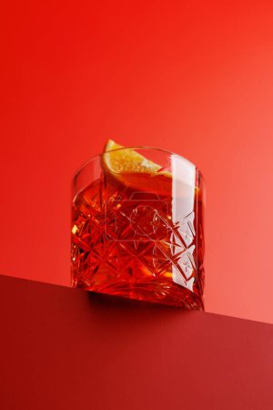 Cocktail delight: Classic negroni against a red background with copy space