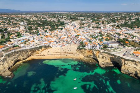 Photo for Landscape of the Portuguese Algarve coast and picturesque Carvoeiro town with beautiful beach. Aerial view of the beautiful Carvoeiro beach with colourful houses, Portugal. Travel destination - Royalty Free Image